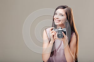 Woman photographer is taking images with dslr camera