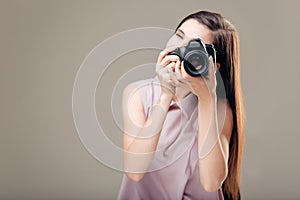 Woman photographer is taking images with dslr camera