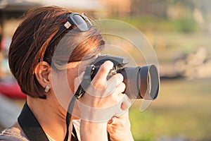 Woman Photographer taking Picture with a DSRL Camera