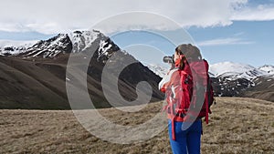 Woman photographing mountains