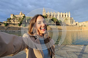 Woman photographing a selfie in Palma de Mallorca Cathedral