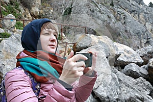 Woman photographs with a smartphone at Chekhov`s dacha