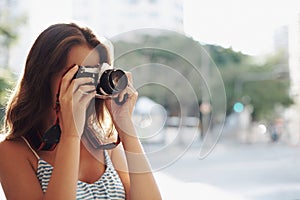 Woman, photography and city street with camera for photo, memory or capturing outdoor moment. Female person, tourist or