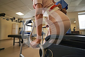 Woman with physical disability using walking frame indoors