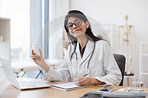 Woman physician using devices and prescribing medication
