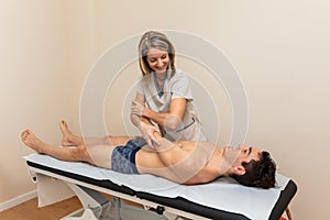 Woman physiotherapist does session to man. tendonitis, glenohuneral