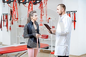 Woman with physiotherapist at the rehabilitation office