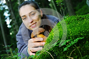 Woman pick up the mushroom