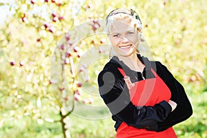 Woman picking apples in orchard