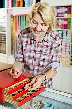 Woman picking buttons and clasps