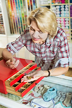 Woman picking buttons and clasps