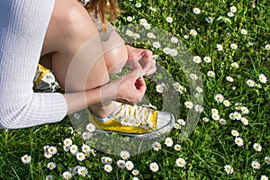 Woman picking daisies in the field