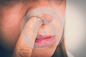 Woman is picking her nose with finger inside - retro style