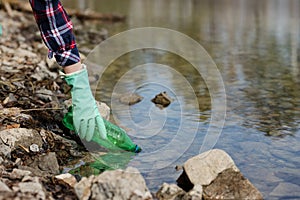 Woman picking up dump on dirty forest