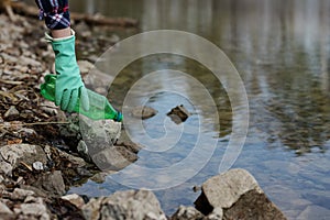 Woman picking up dump on dirty forest