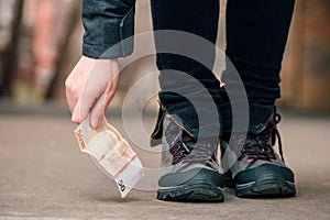 Woman picking up money found on the street