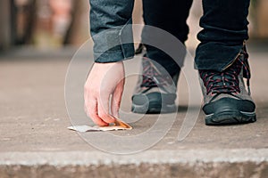 Woman picking up money found on the street