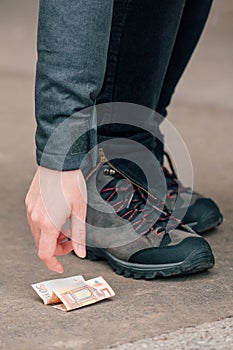 Woman picking up money found on the street