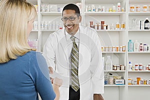 Woman Picking Up Prescription Drugs At Pharmacy photo