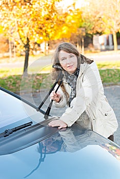 Woman picking up windscreen wiper