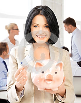 Woman with piggy bank and cash money