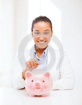 Woman with piggy bank and coin