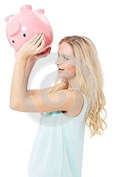 Woman, piggy bank and finance or savings in studio with cash investment, financial growth or wealth. Person, money box
