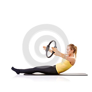 Woman, pilates ring and yoga mat for balance exercise or resistance training, strong core or studio white background