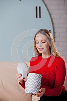 Woman with pile of presents at home