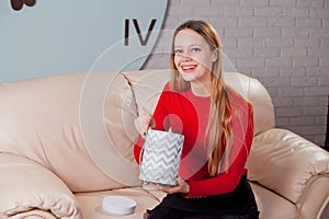 Woman with pile of presents at home