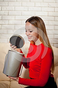 Woman with pile of presents at home