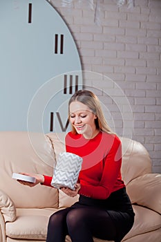 Woman with pile of presents at home