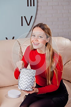 Woman with pile of presents at home