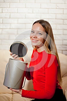 Woman with pile of presents at home