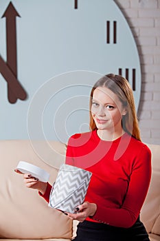 Woman with pile of presents at home