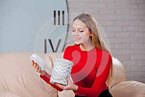 Woman with pile of presents at home