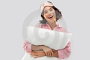 Woman with pillow in pajama and eye sleeping mask