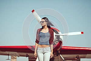 Woman pilot and airplane