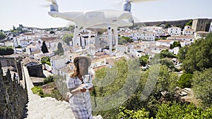 Woman piloting drone in old town
