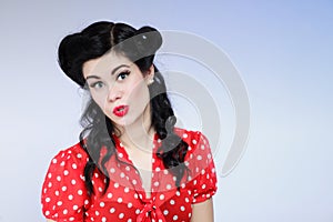 Woman pin-up make-up hairstyle posing in studio