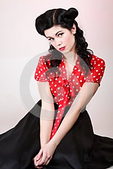 Woman pin-up make-up hairstyle posing in studio