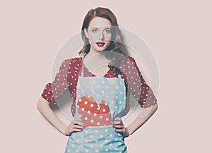 Woman in pinafore with potholder photo