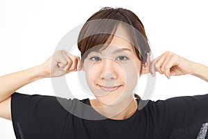 Woman pinches her ears.