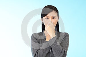 Woman pinches her nose