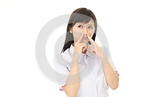 Woman pinches her nose