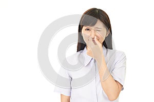 Woman pinches her nose