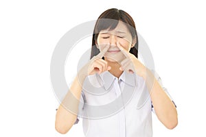 Woman pinches her nose