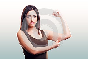 Woman pinching flabby fat arm skin