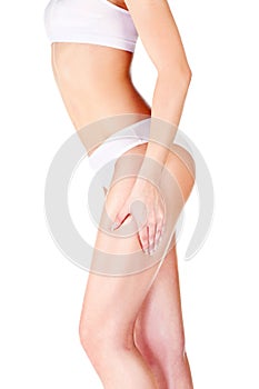 Woman pinching leg for skin fold test