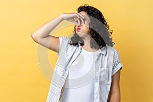 Woman pinching nose, stop breathing bad odor, disgusted by smell of farting, expressing repulsion. photo